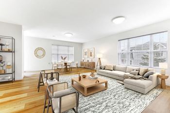 A living room with a couch coffee table and chairs